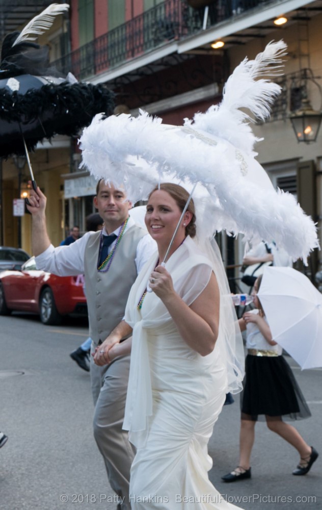 A Happy Couple Walking in their Wedding Day Second Line, French Quarter, New Orleans © 2018 Patty Hankins