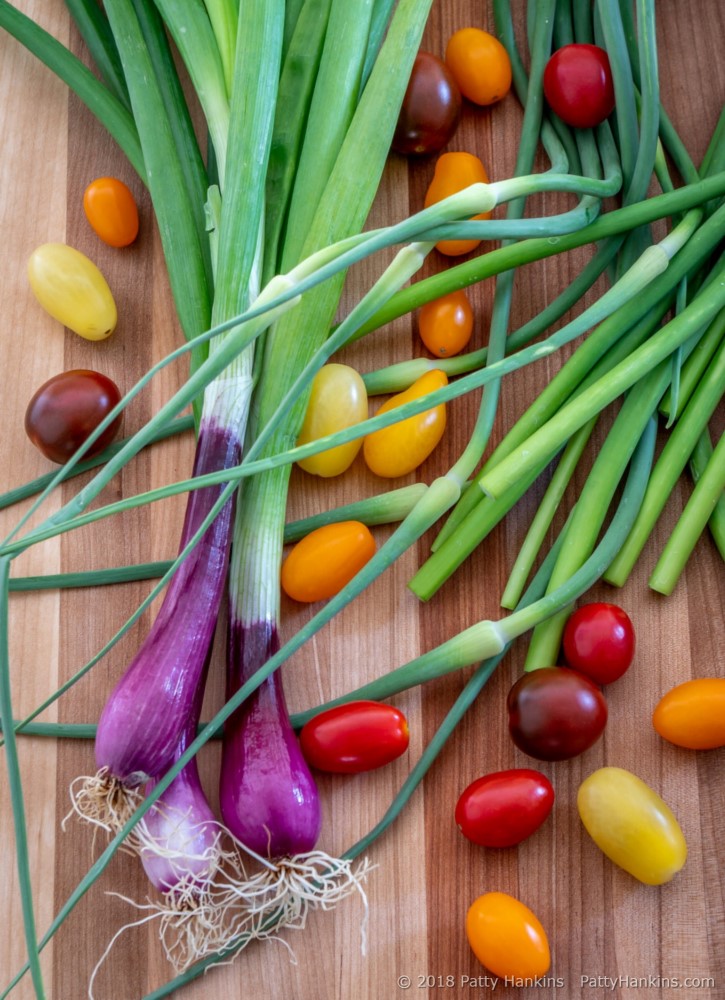 Spring Onions, Garlic Scapes and Cherry Tomatoes © 2018 Patty Hankins